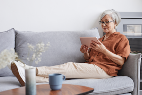 Life Assure Senior Woman Relaxing With iPad Tablet Blog